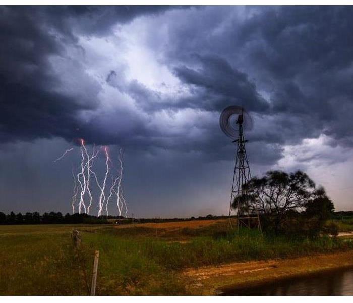 Lightning strikes in an open field.